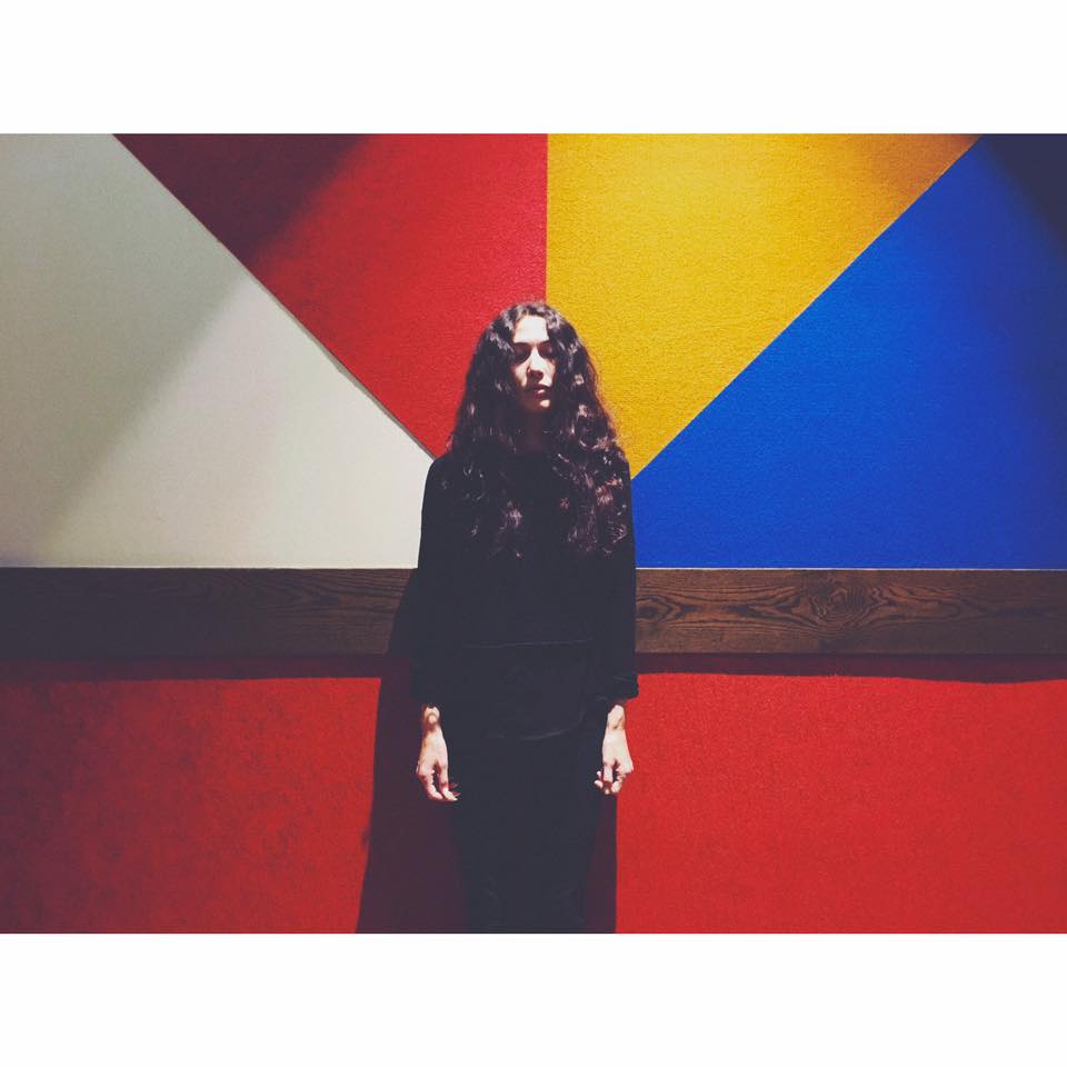 Lauren Barth standing in front of brightly colored wall